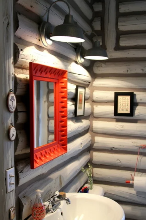 blockhaus aus holz fabriklampen an der wand roter spiegelrahmen