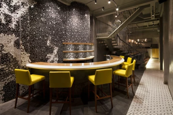 Wandgestaltung mit Mosaikfliesen im Nudel Restaurant barhocker lehnen gelb