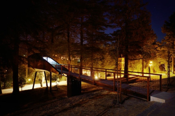 Zwei schlangenartige Hütten im Wald baustrukturen nacht