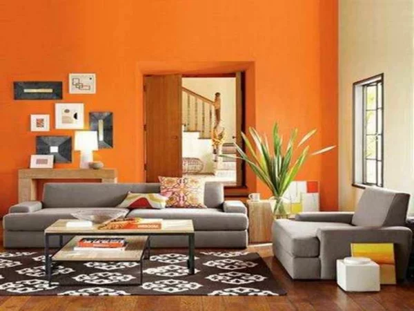 wohnzimmer farbideen modern orange wand akzent sofa teppich 