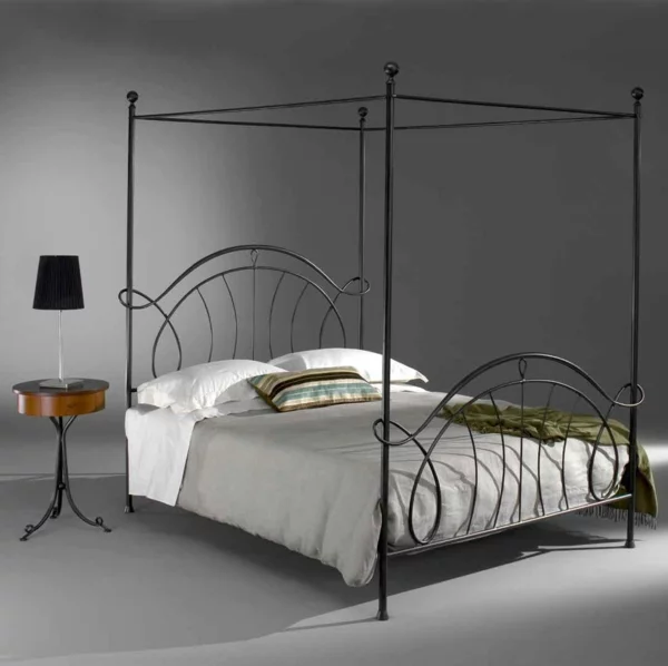 schlafzimmer gestalten metallbett himmelbett schmiedeeisen vintage design runder beistelltisch nachtkonsole tischleuchte ambar muebles