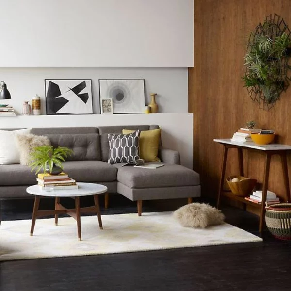 modernes Wohnzimmer trendige Einrichtungsideen Teppich Holzboden schicke Möbel runder Couchtisch aus Holz 