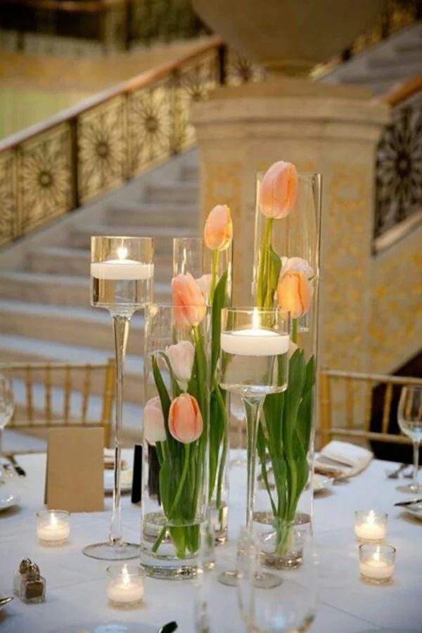 elegante tischdeko mit tulpen kerzen glasvasen voll wasser