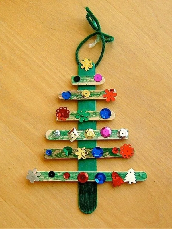 Basteln mit Kindern Weihnachtsbaum aus Eisstielen mit Schmuckperlen und Knöpfen dekoriert 