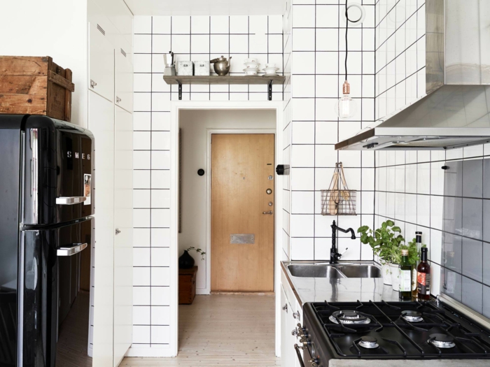 kücheneinrichtung schwarzer retro kühlschrank weiße wandfliesen pflanzen