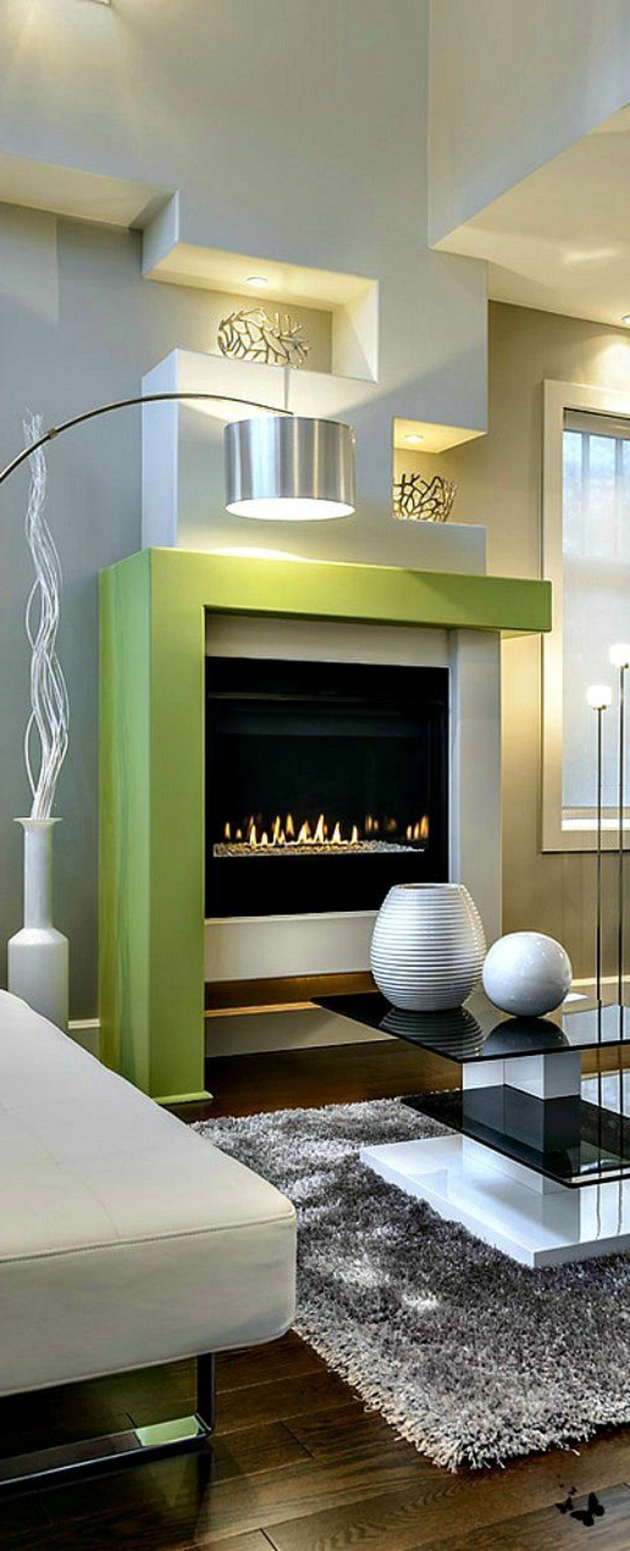kamin design wohnzimmer einrichten grauer teppich grüne akzente