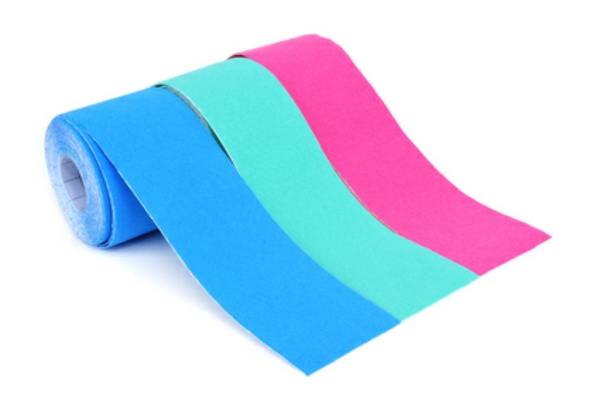 some rolls of elastic therapeutic tape of different colors, pink and two different shades of blue, on a white background