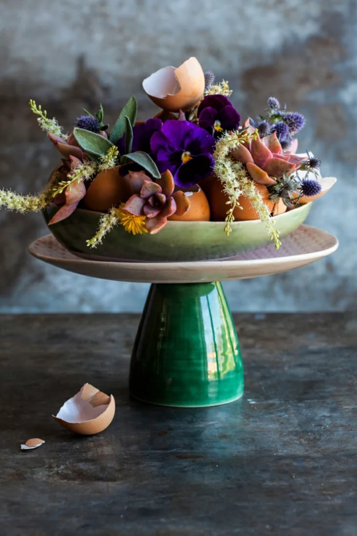 Osterdeko selber gestalten mit frischen Blüten und Eierschalen auf Porzellan-Tortenständer 