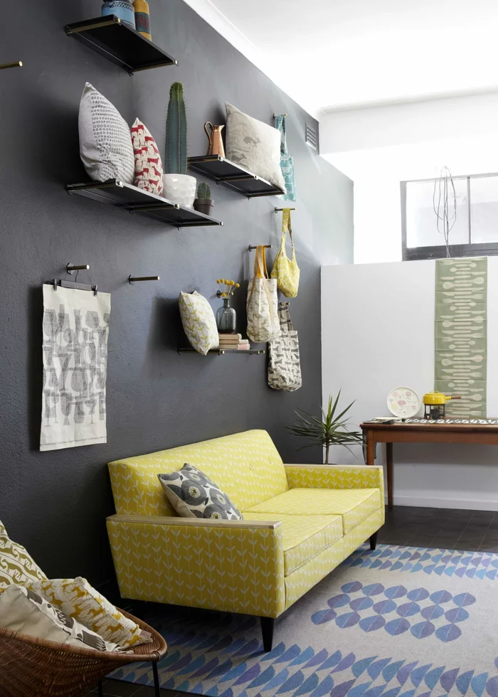 schwarze wandfarbe akzentwand gelbes sofa heller teppich wohnzimmer einrichten