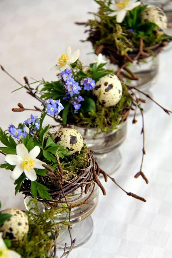 tischdeko ostern ostertischdekoration ideen gläser weidenzweige nest frühlingsblumen wachteleier