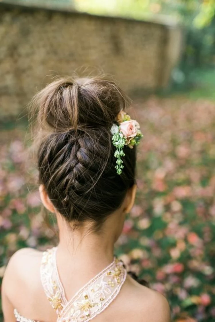 Kommunionfrisuren für Mädchen hochgesteckte Haare mit Zopf und Blume im Haar 
