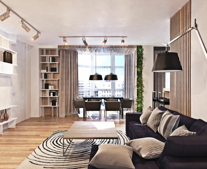 modern einrichten wohnzimmer teppichmuster dunkles sofa essbereich helle wände grüne akzente