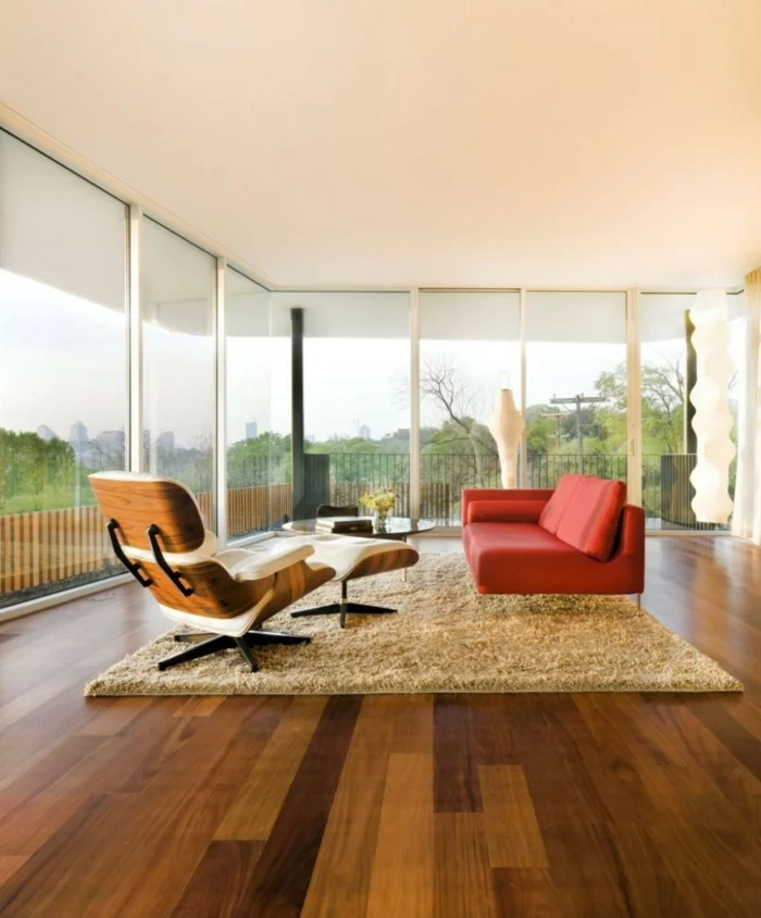 wohnzimmer einrichten beispiele minimalistisch oranges sofa beiger teppich panoramafenster
