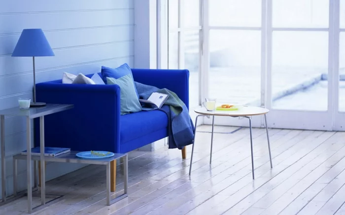 blaues Sofa, blaues Wanddesign und blaue Tischlampe