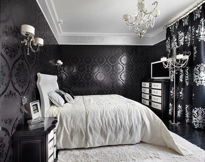 Schlafzimmer in Schwarz mit einem weißen Teppich und weißer Bettwäsche