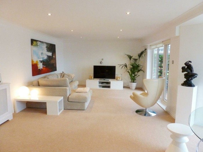 schönes wohnzimmer einrichten ideen teppichboden fernseher weiße wände