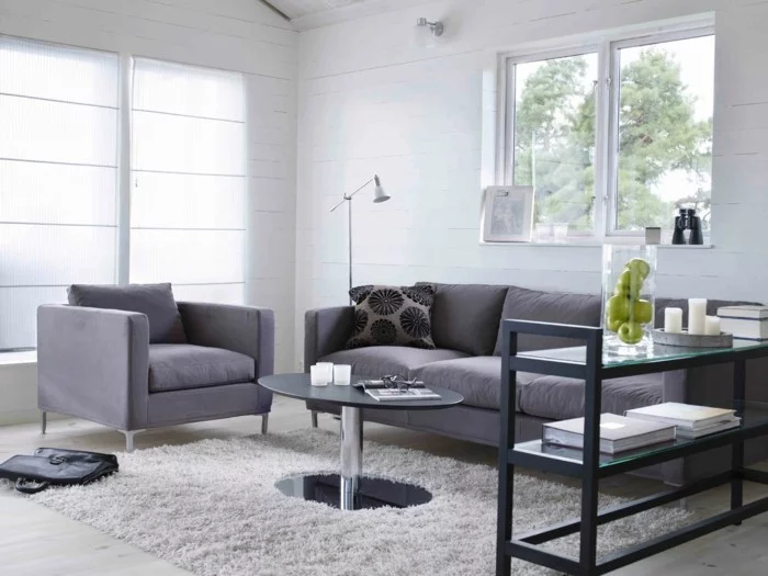 Wohnzimmer gestalten mit weißem Wanddesign, weißem Teppich und grauen Möbeln