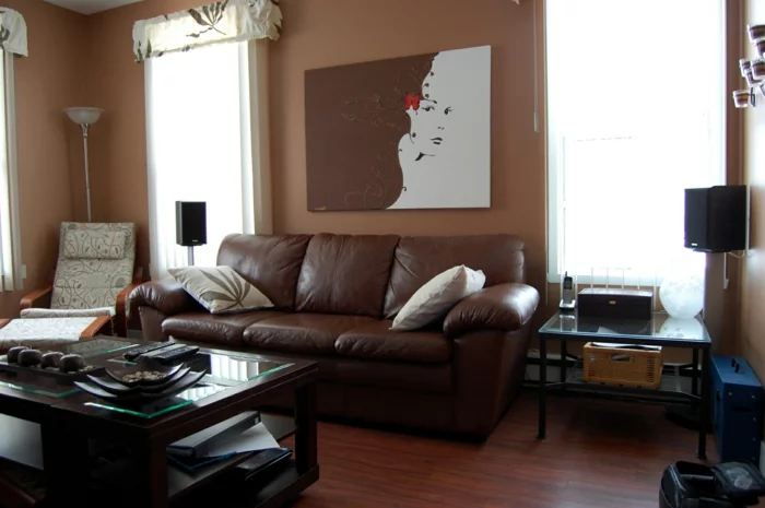 Wohnzimmer in Braun mit einem funktionalen Couchtisch und Wandbild in Braun und Weiß