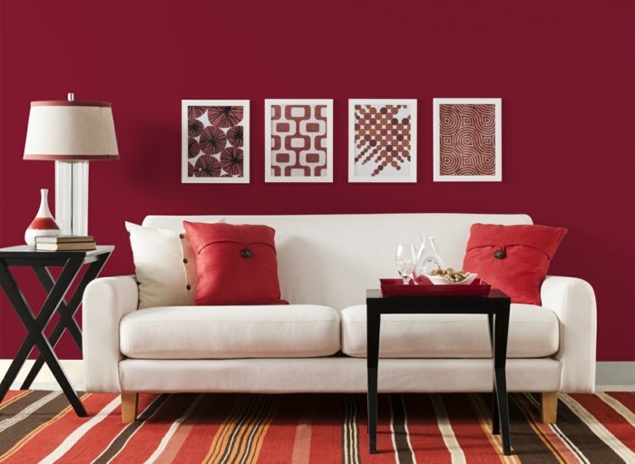 wohnideen wohnzimmer rote wände weißes sofa streifenteppich