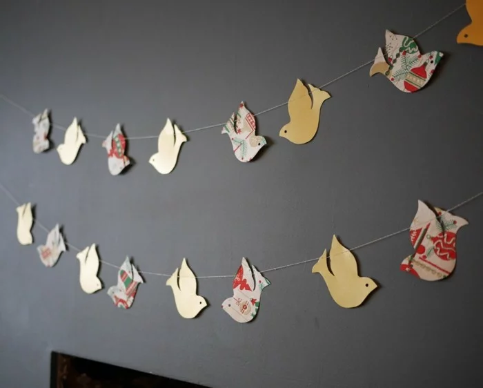 Zimmer Deko DIY Idee mit Girlande aus Papiervögeln in verschiedenen Farben und Mustern