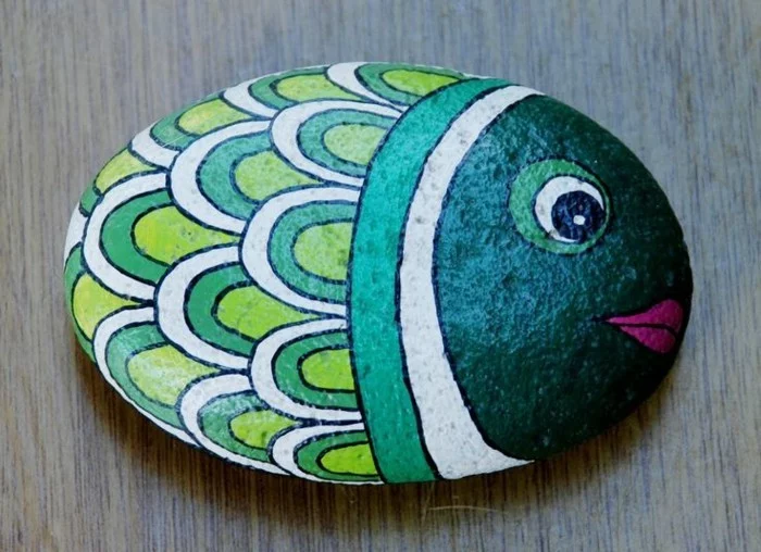 ovaler Stein gestaltet als Fisch in Grün und Weiß 