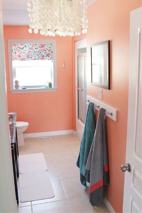 kleines Badezimmer mit Wandfarbe Apricot und schönem Leuchter