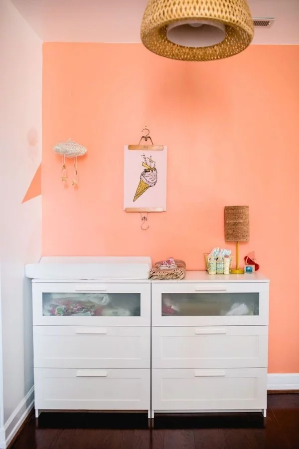 Wandfarbe Apricot und weiße Kommoden im Kinderzimmer