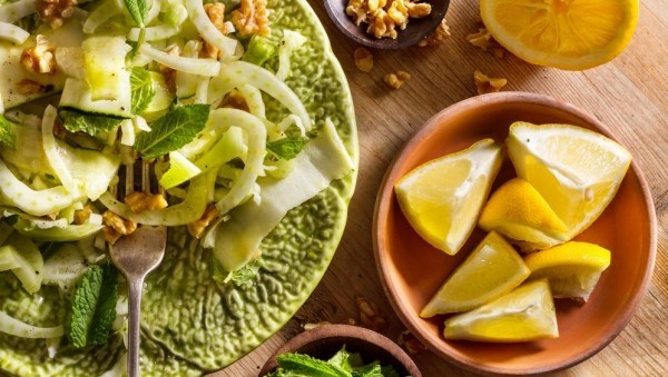 Frischer Fenchel Salat mit Walnüssen  Zucchinis grüne Minze Blätter Zitronenstückchen