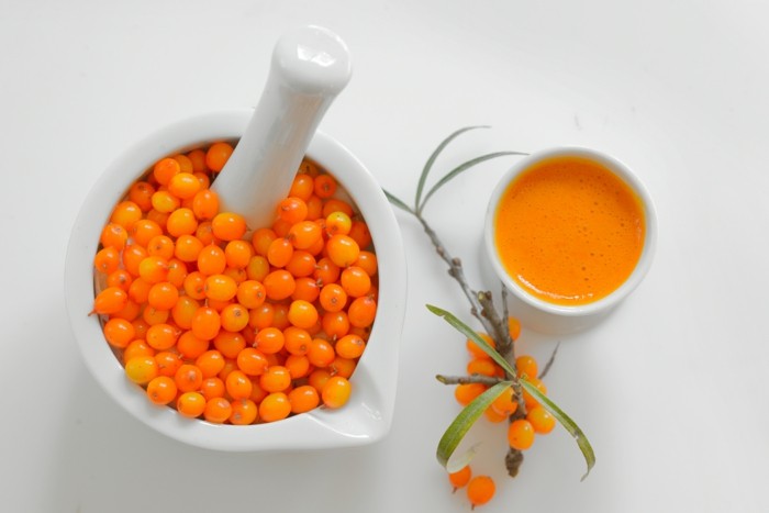 sea buckthorn berries and juice isolated