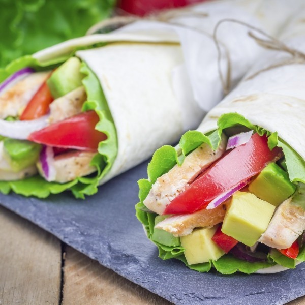 Tortilla wraps with roasted chicken fillet, avocado, tomato, onion and puprika