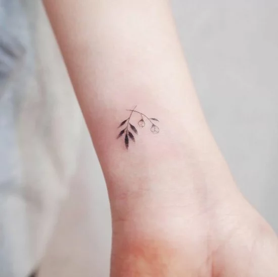 Mikro Tattoo mit Blüten am Handgelenk