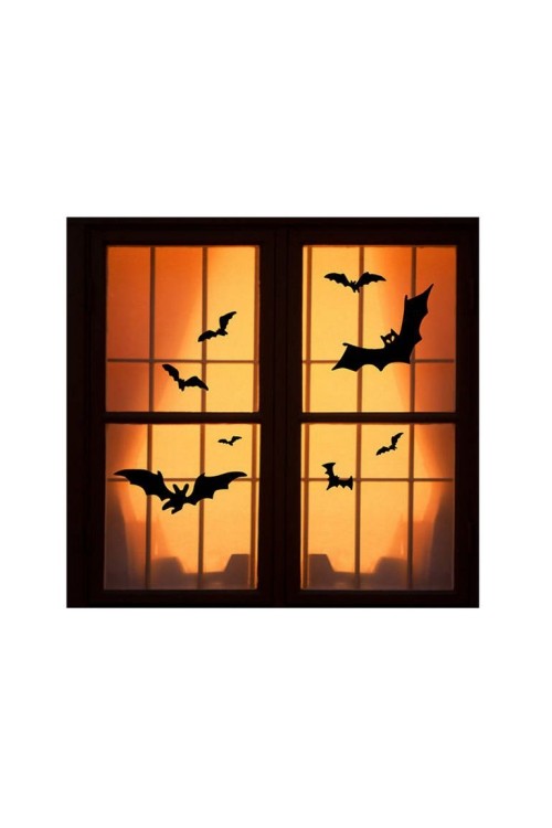 Halloween Fensterdeko schwarze Fledermäuse auf orangenfarbenem Hintergrund gut beleuchtet