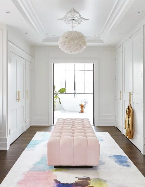 Begehbarer Kleiderschrank luxuriöse Einrichtung rosa Sitzbank Teppich