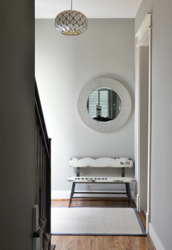 Dekorative Wandspiegel im Flur Design in Grau kleine rustikale Sitzbank kleiner runder Spiegel