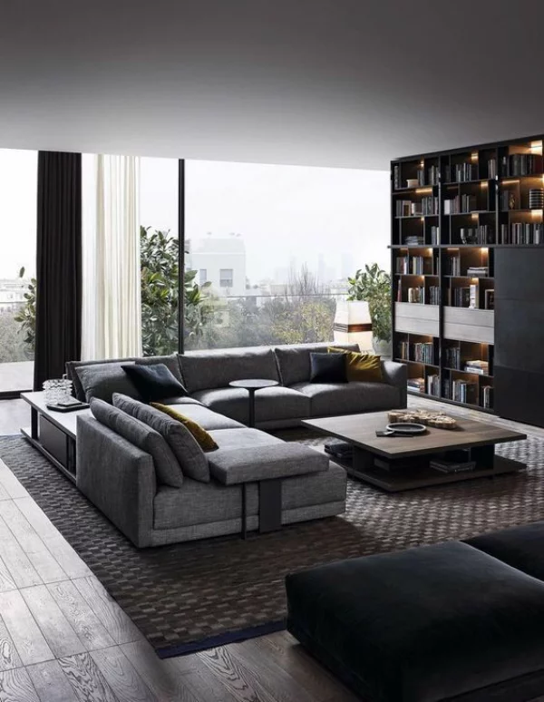Maskulin und elegant modernes Wohnzimmer bequeme graue Möbel modernes Bücherregal interessante Beleuchtung