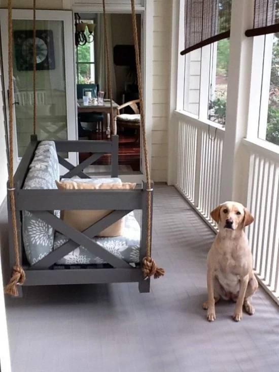 Hängebett draußen einfaches Modell auf der überdachten Veranda Hund daneben