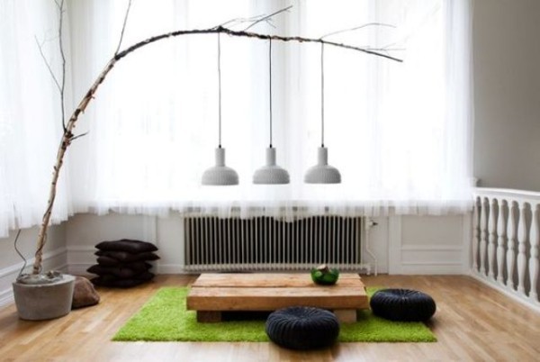 Japanisches Wohnzimmer Natur präsent Zweig Hängeleuchten niedrige Möbel Bodenkissen grüne Matte