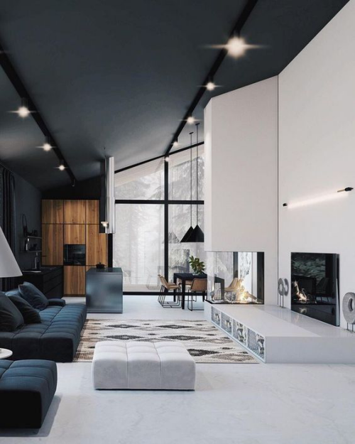 Wohnzimmer in Schwarz-Weiß niedrige elegante Möbel hohe Decken Glasfenster Kamin Fernseher viel Charme Raffinesse