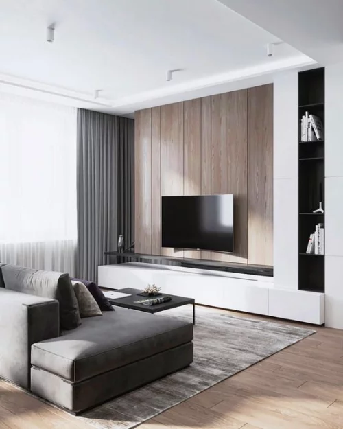 Minimalismus im Wohnzimmer perfektes Design bequemes Sofa in Grau Flachfernseher Teppich Gardinen alles im visuellen Einklang