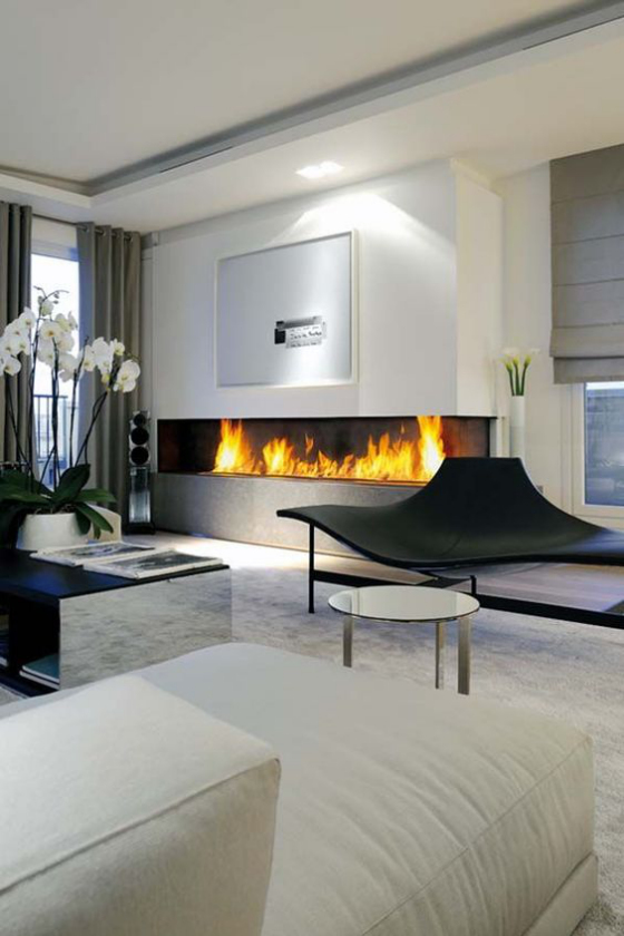 Moderne Kamine traumhaftes Wohnzimmer eingebauter Kamin weiße Möbel weiße Orchideen