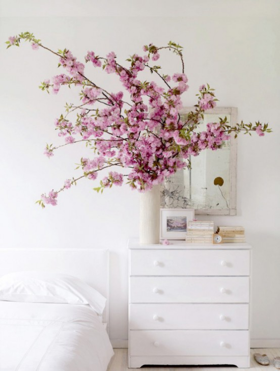 Frühlingsdeko mit Kirschblüten rosa Blüten in Vase weiße Kommode Wandspiegel