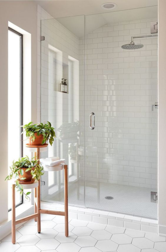 Badezimmer ganz in Weiß kleiner Blumenständer Badpflanzen komplettieren den Look