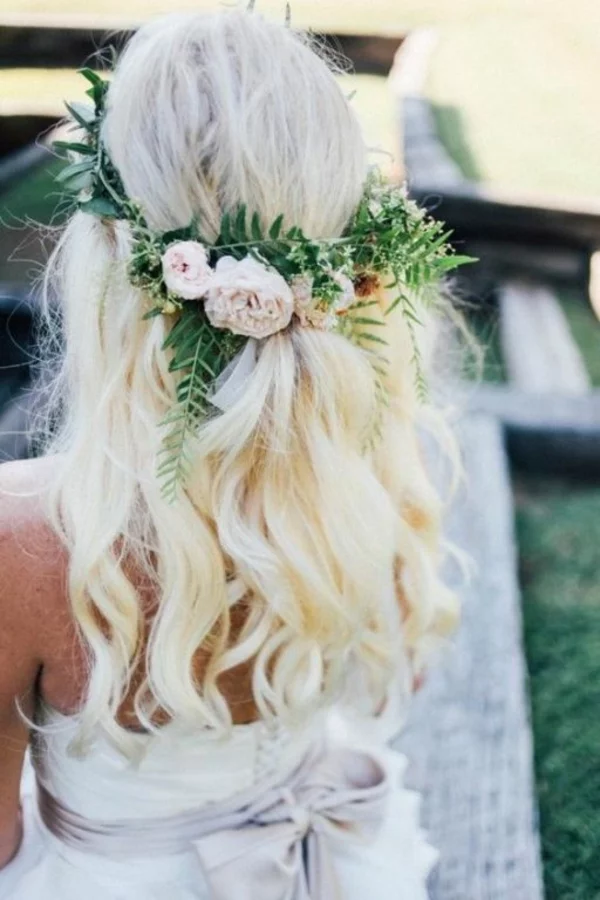 Brautfrisur offen mit Blumen blonde Haare Wellen