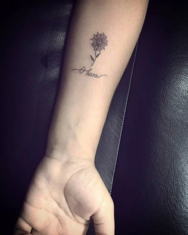 Micro Tattoo mit Ohana Schriftzug und Sonnenblume 