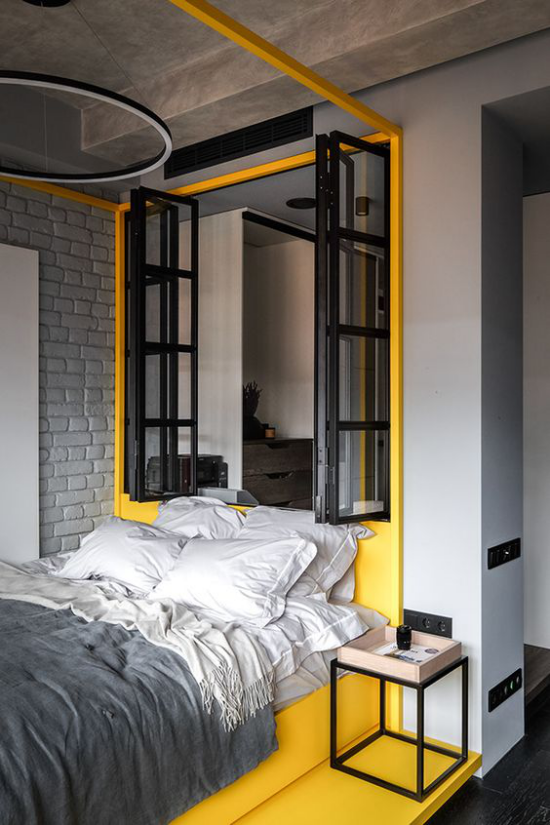 Schlafzimmer Ideen in Grau und Gelb attraktive Raumgestaltung Sonnengelb Schwarz Fensterrahmen graue Bettwäsche gelb am Boden an der Wand