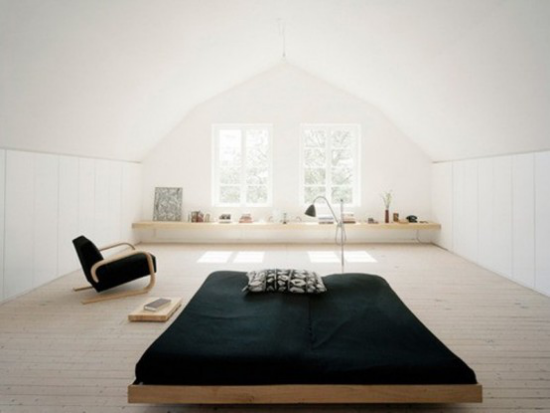 Zen Schlafzimmer weite freie Raumfläche großes Fenster bequemes Schlafbett schwarzer Sessel