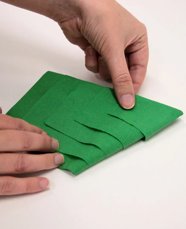 genaue Anleitung Schritt 5 Tannenbaum Servietten falten grüne Papierserviette 