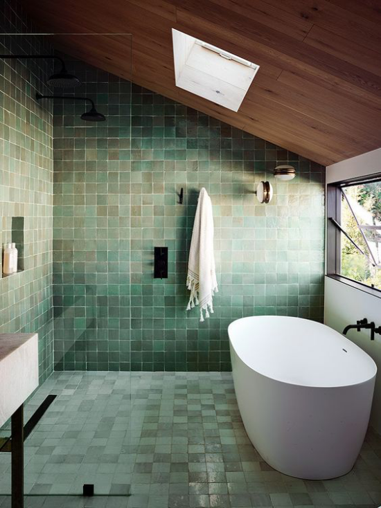Badezimmer Trends 2021 grüne Wand-und Bodenfliesen verschiedene Schattierungen weiße Badewannen Fenster rechts Dachfenster oben viel Licht