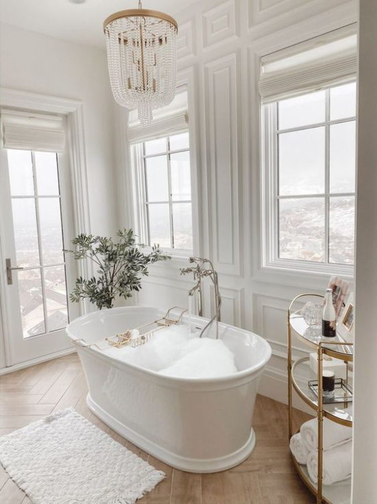 Badezimmer Trends 2021 klassisches Baddesign freistehende Badewanne Holzboden alles andere in Weiß