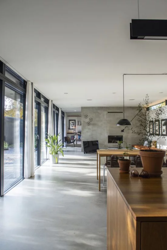 grauer Boden Betonboden minimalistischer offener Raum links deckenhohe Fenster viel Tageslicht